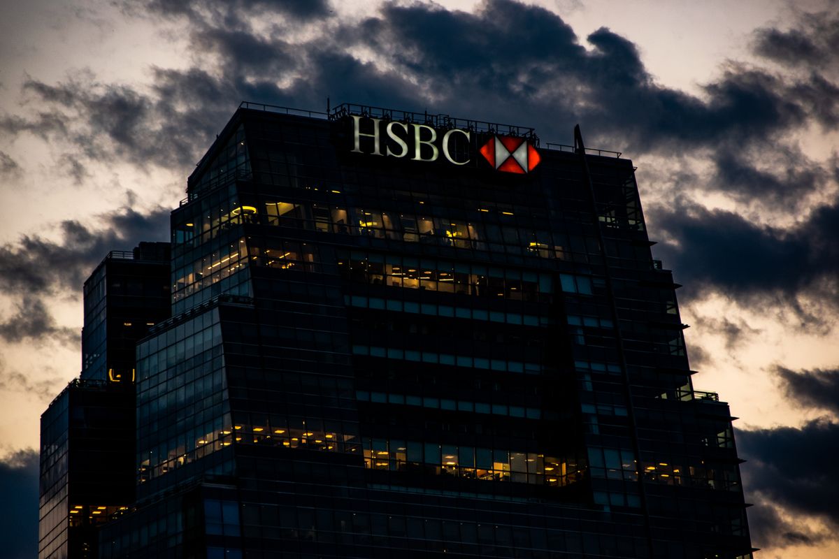 Illuminated bank office tower against an evening sky in a financial district