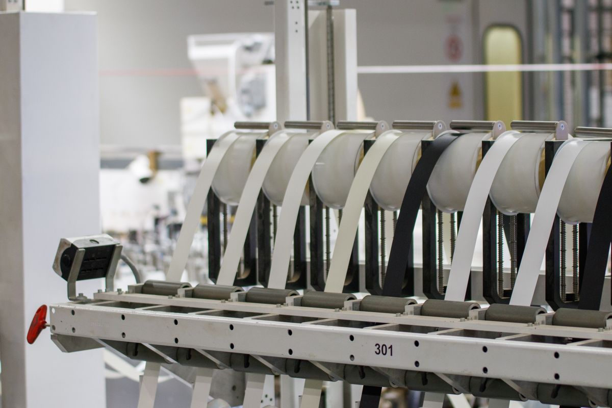 Automated machinery on a factory production line, illustrating capital and labor combining as factors of production