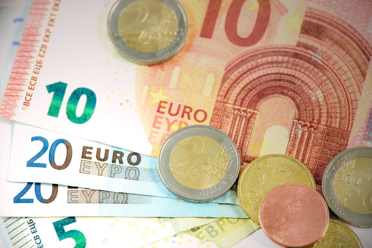 Euro banknotes and coins representing everyday market transactions
