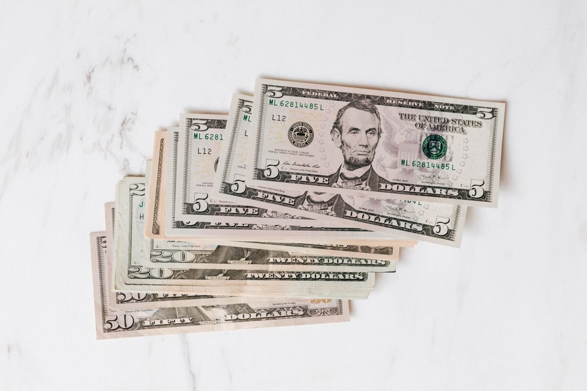 Neat stacks of US dollar bills on a surface