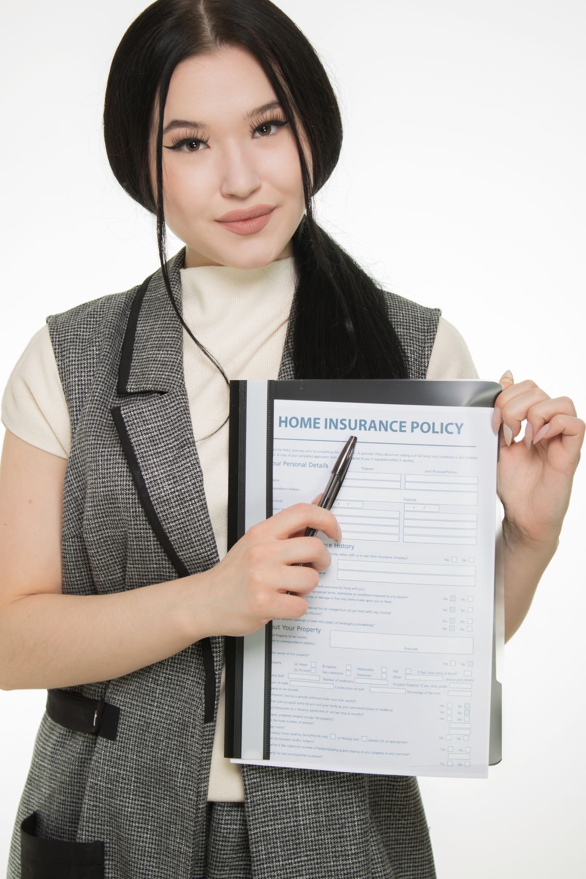 Insurance professional presenting a policy document with a pen