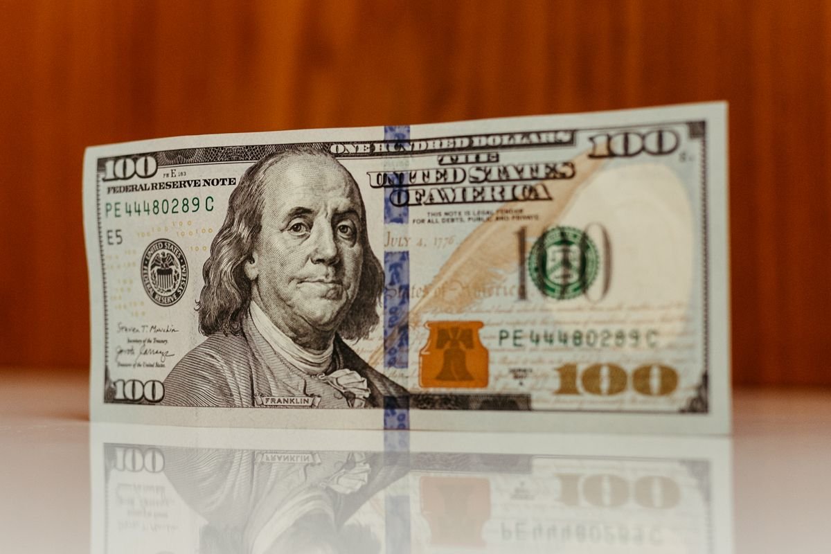 Close-up of US one hundred dollar bills representing sovereign debt