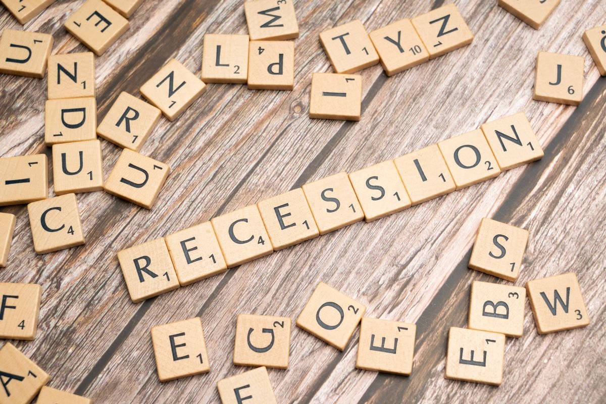 The word recession spelled out in Scrabble letter tiles