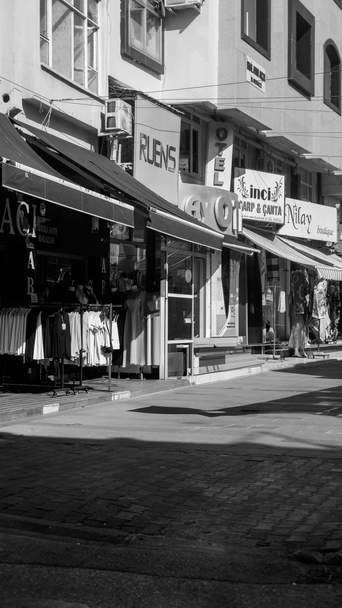 Street of shopfronts and storefront signage in a commercial district