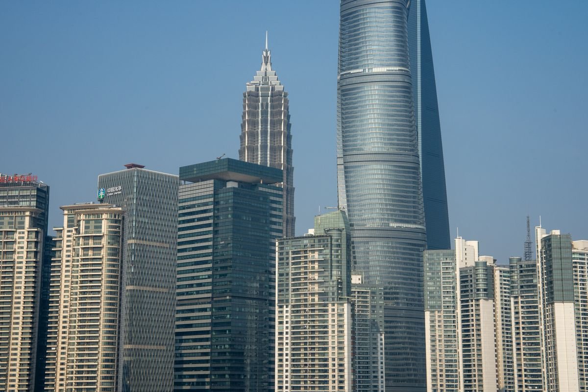 Skyscrapers in Shanghai financial district under a clear sky, symbolizing emerging-market growth