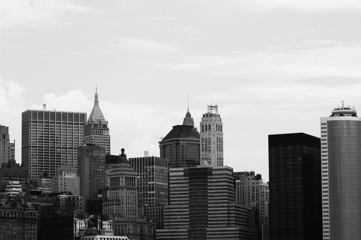 A dense modern city skyline representing finance-driven high-income economies