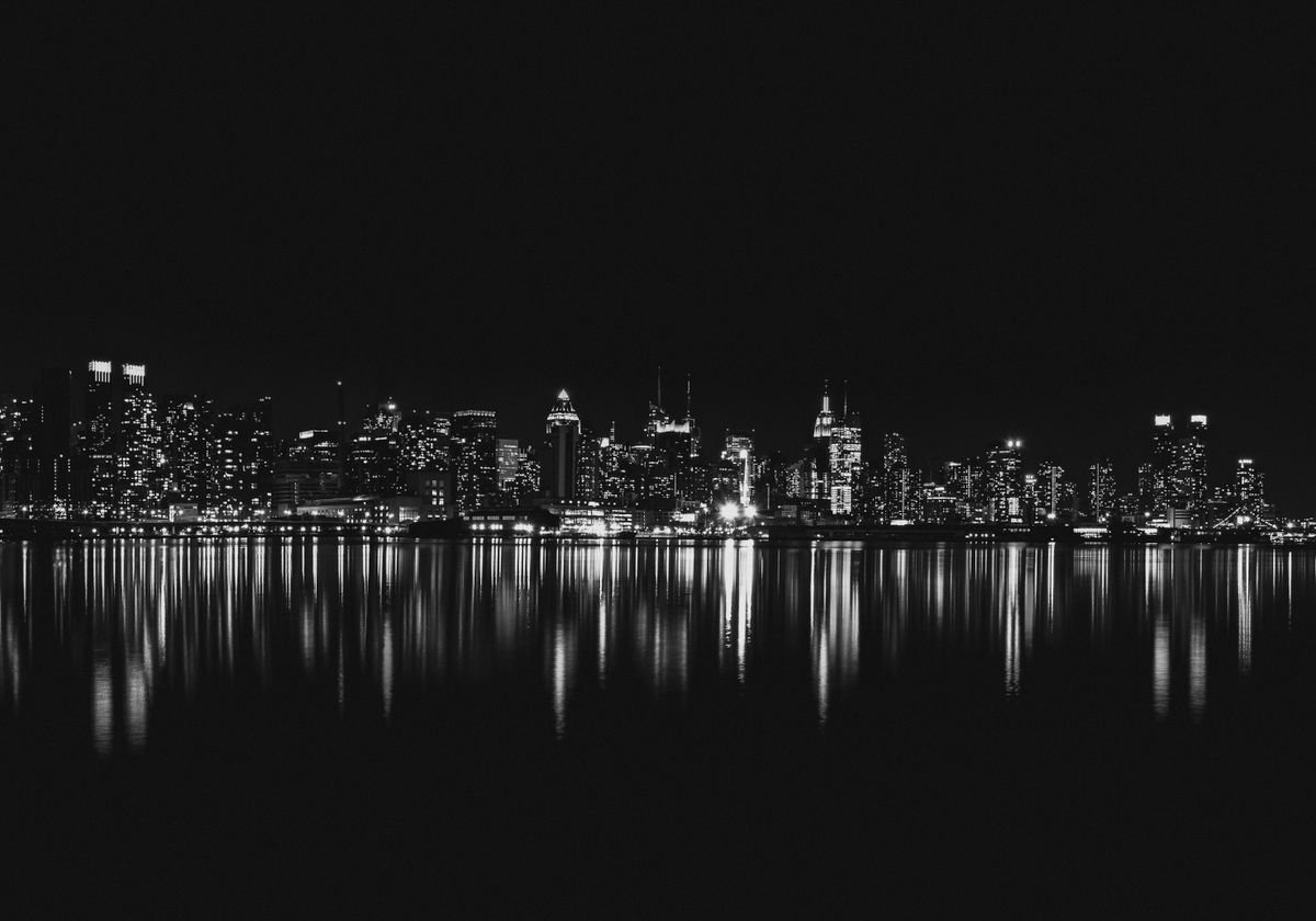 City skyline reflected on water at night symbolizing global finance